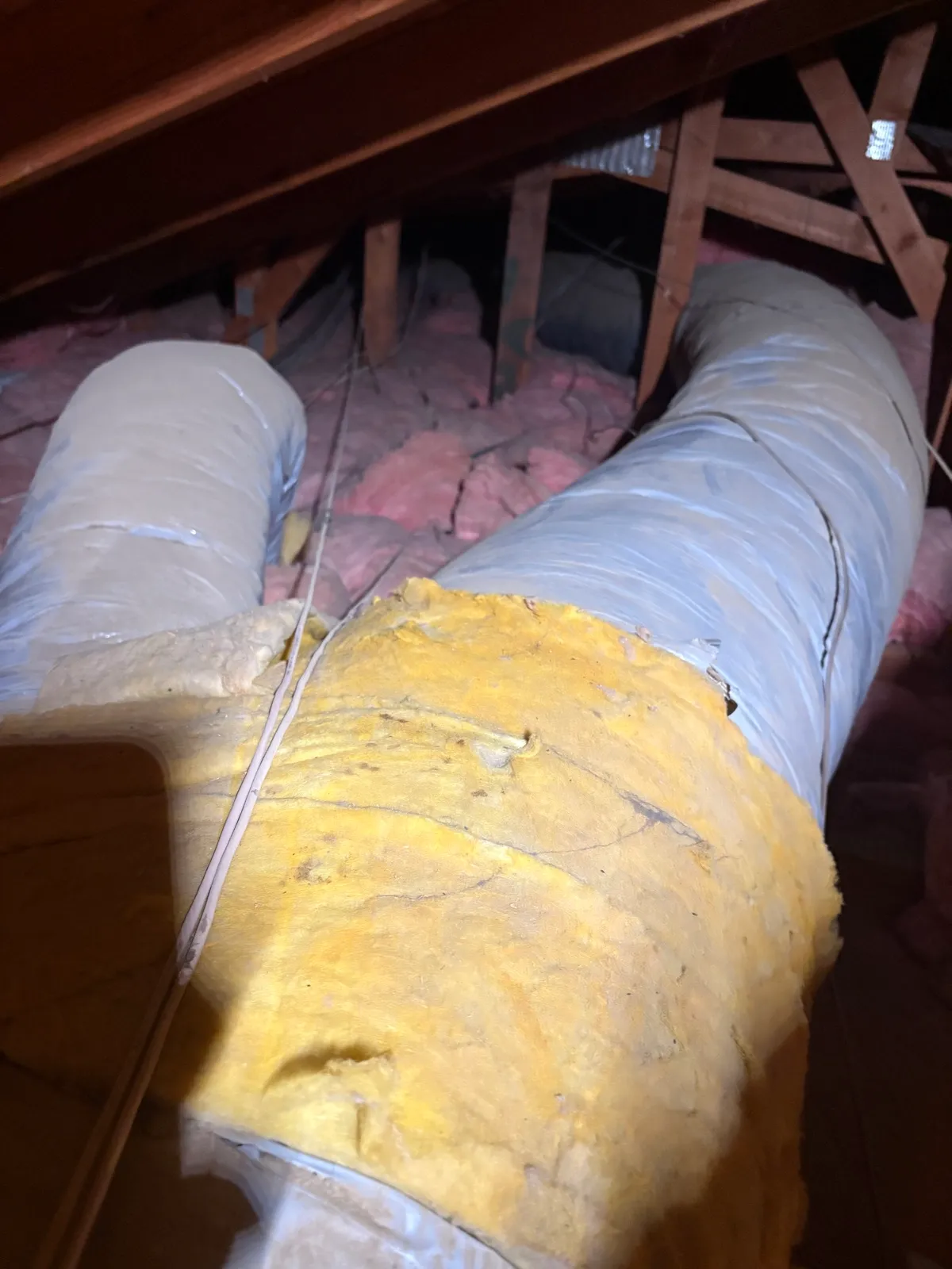 New ductwork wrapped in fiberglass insulation by Abundant Air