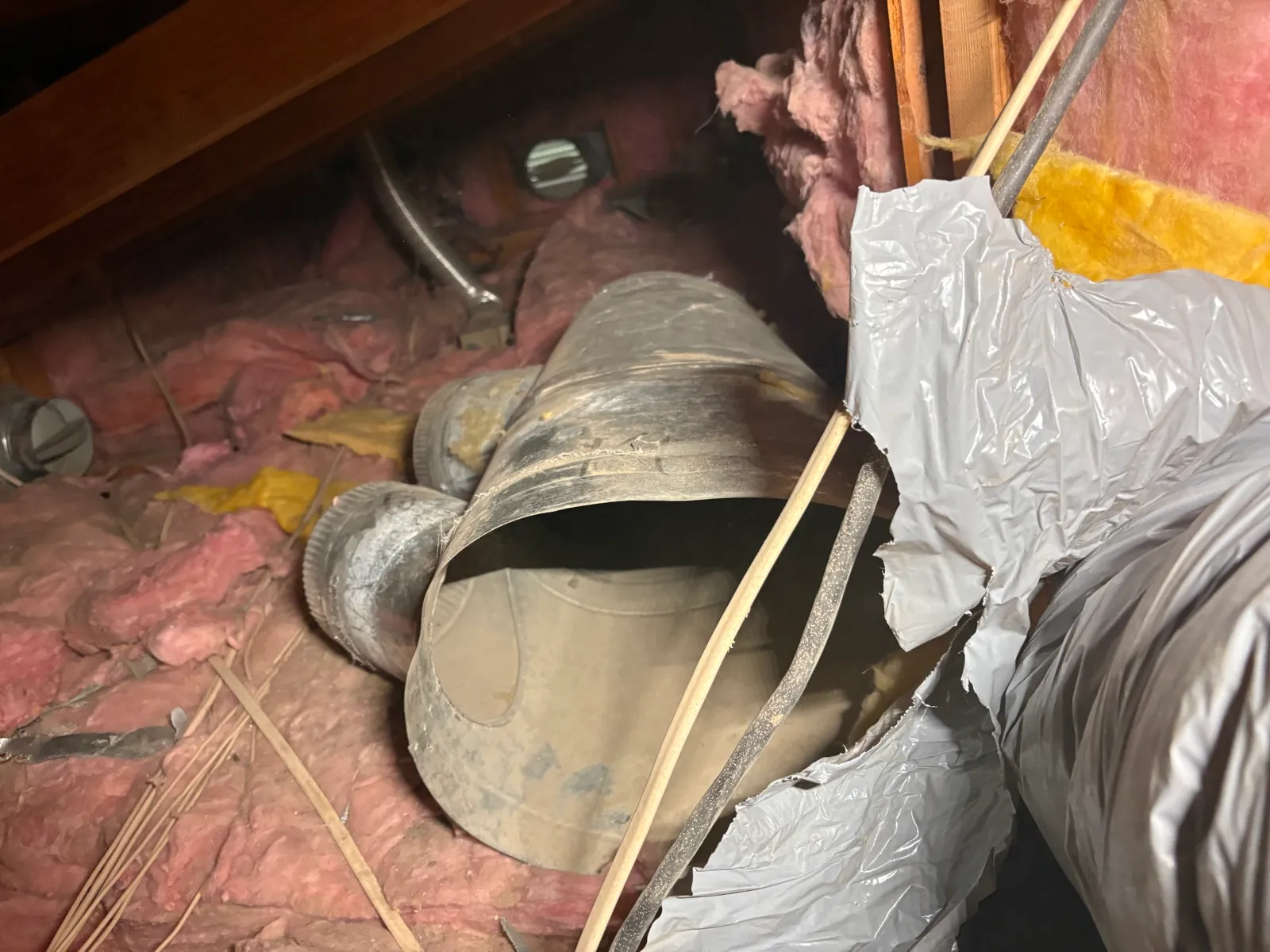 Crushed sheet metal duct elbow and torn flex duct before repair, La Quinta CA