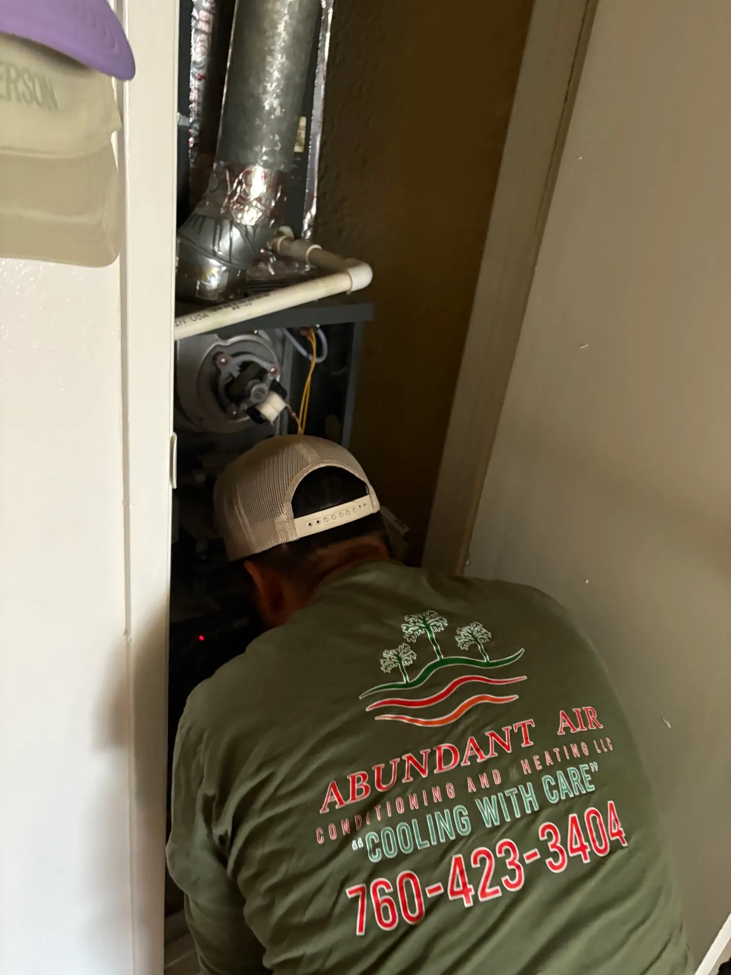 Abundant Air technician servicing HVAC equipment in the Coachella Valley